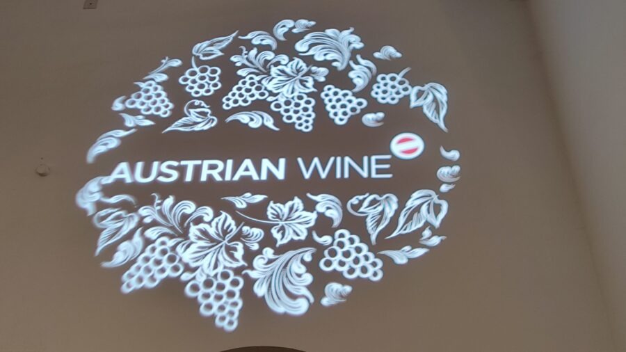 Leuchtendes AUSTRIAN WINE-Logo mit Reben- und Traubenornamenten bei der VieVinum 2026 in der Wiener Hofburg.